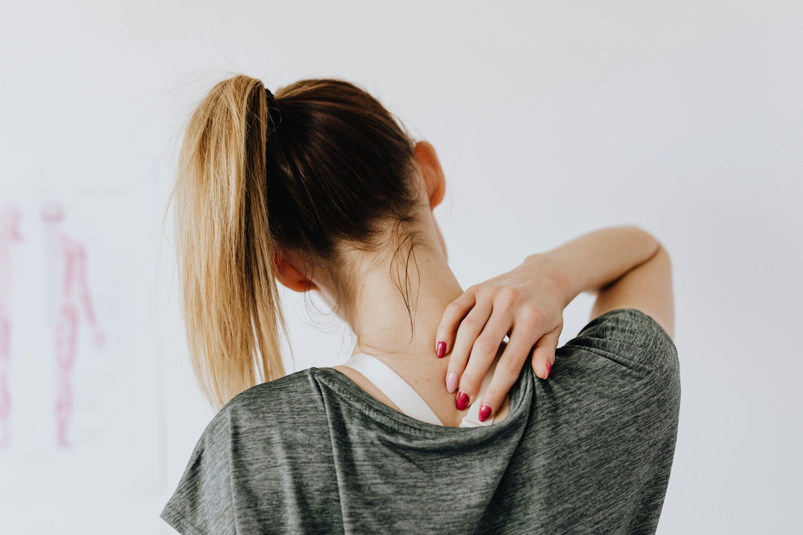 Patient holding their neck/upperback