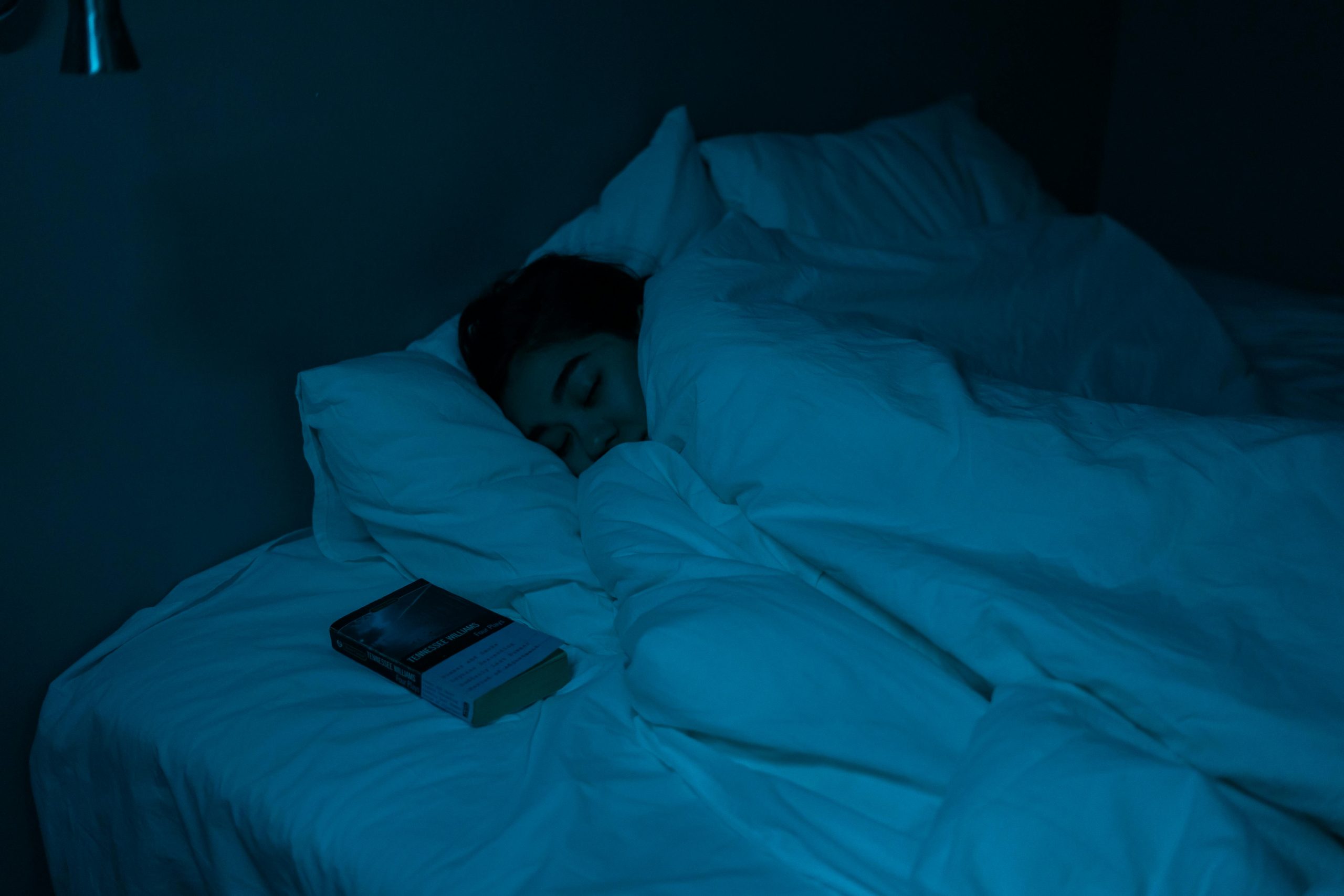 Person sleeping in a dark room.