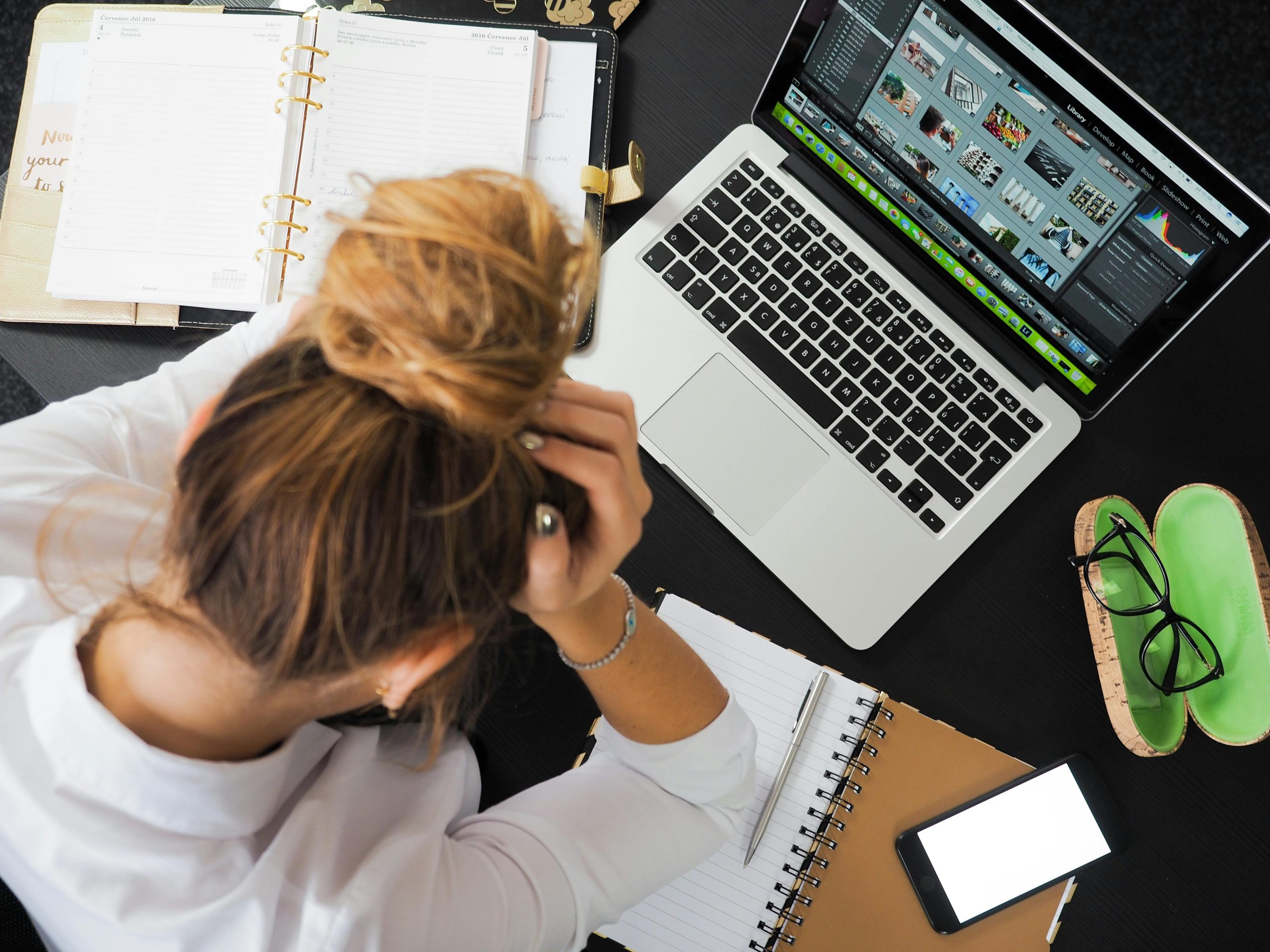 Person stressed while doing computer work.