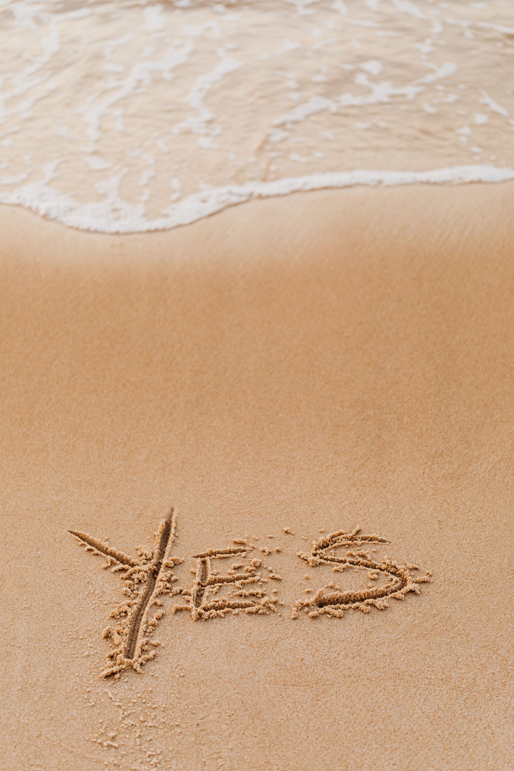 Ocean Sand with the word yes inscribed in it.
